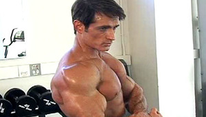 Very awesome stud exercising and lifting weights in a gym 